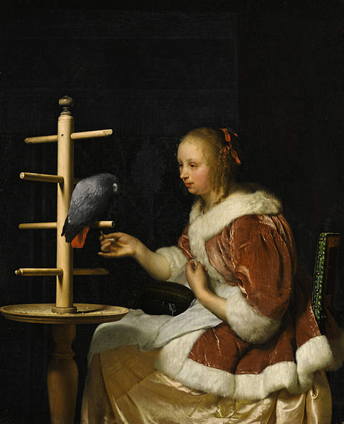A Young Woman in a Red Jacket Feeding a Parrot